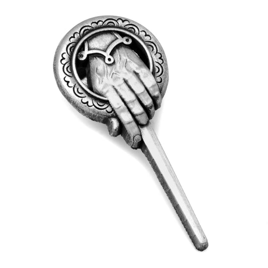 Decorative hair stick with hand and crescent moon design on a white background