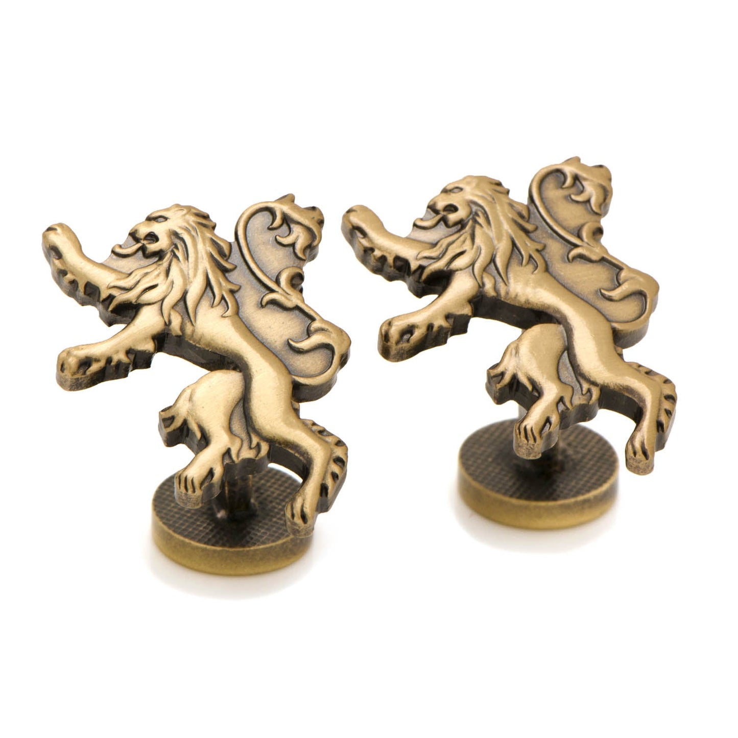 Pair of brass lion figurines on stands against a white background