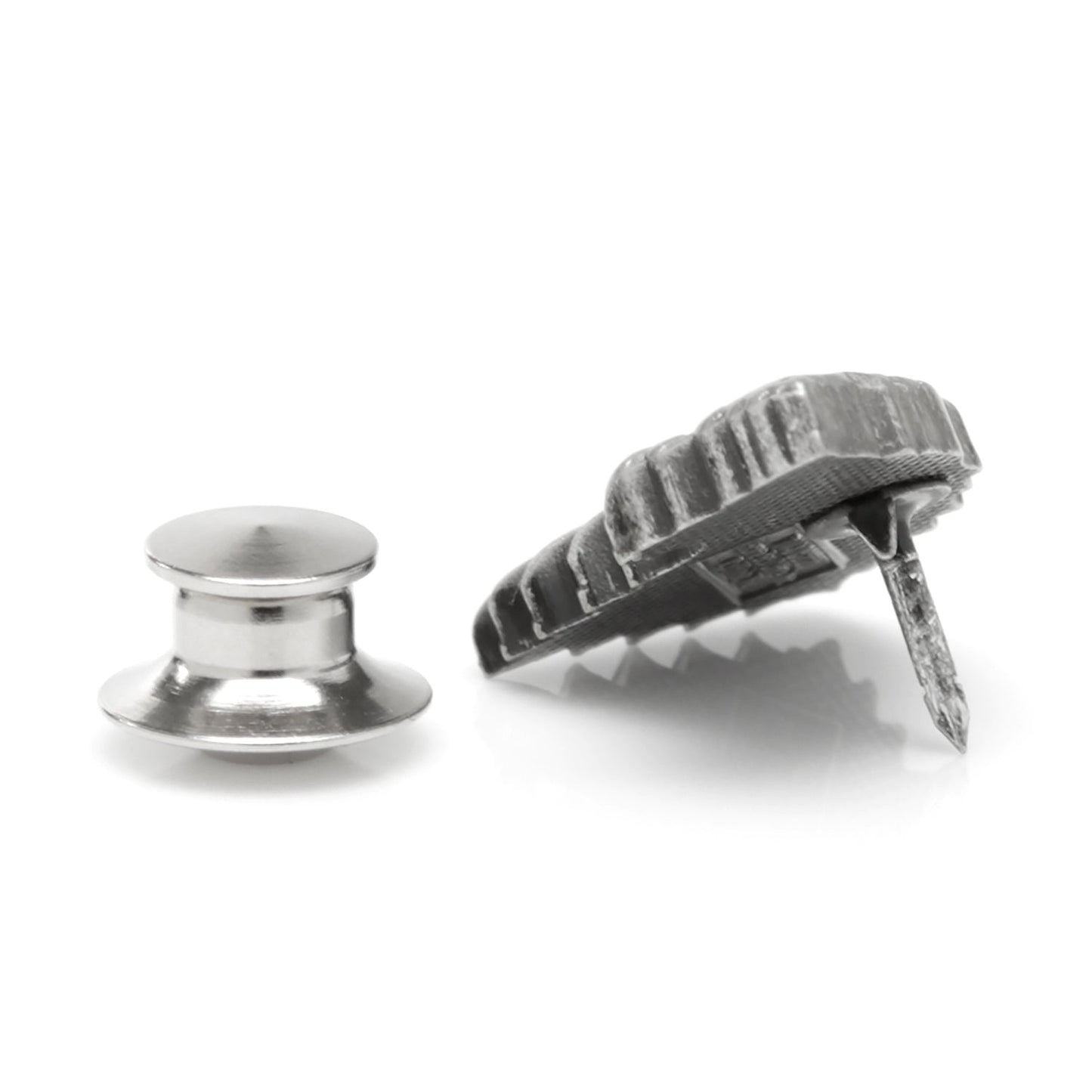 Two metal objects, one round and one with a textured surface, on a white background