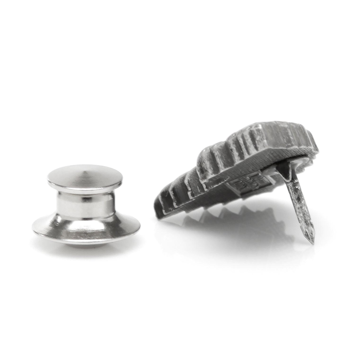 Two metal objects, one round and one with a textured surface, on a white background