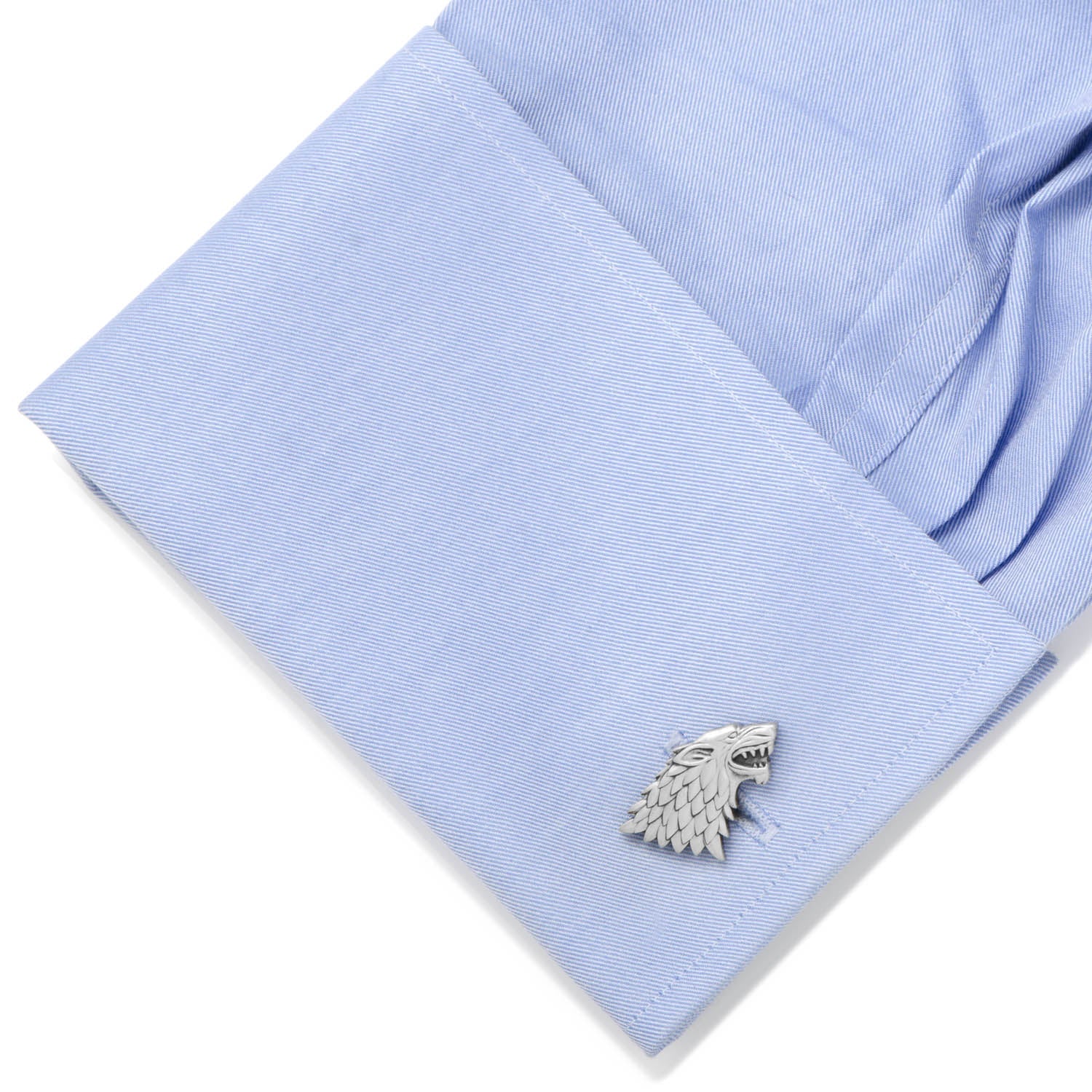 Cufflink on a light blue shirt cuff