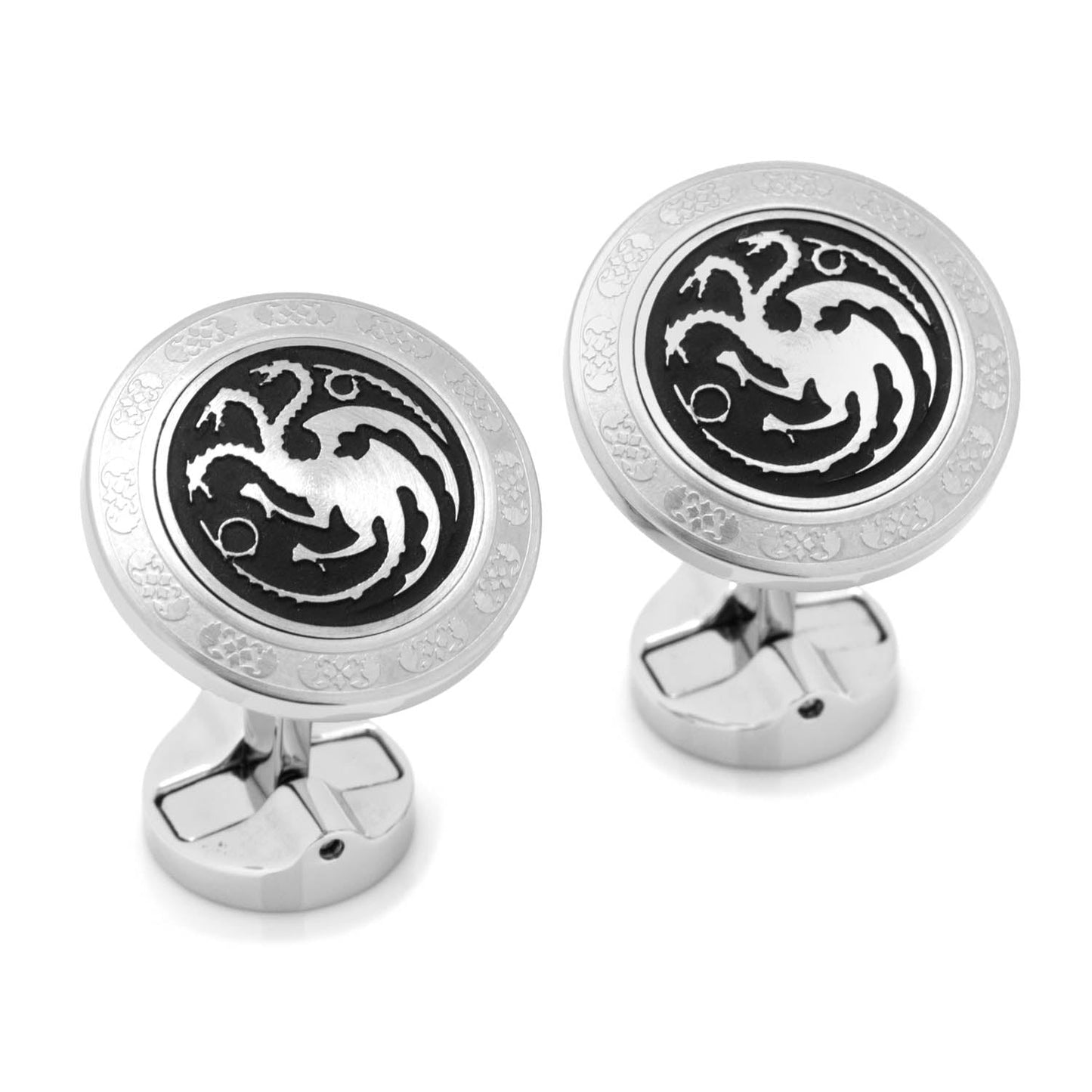 Silver cufflinks with black dragon design on a white background