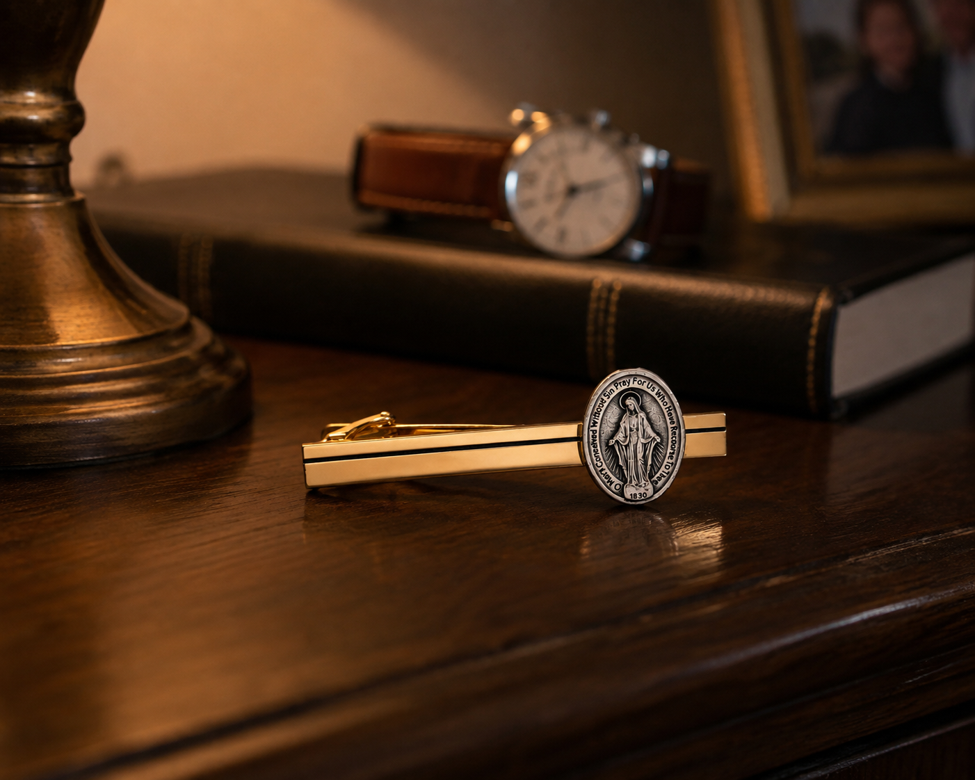 Gold Miraculous Medal tie clip featuring a polished gold tie bar with a silver-tone Catholic Miraculous Medal for men's formal wear.
