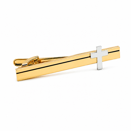 Gold tie clip with a silver cross on a white background