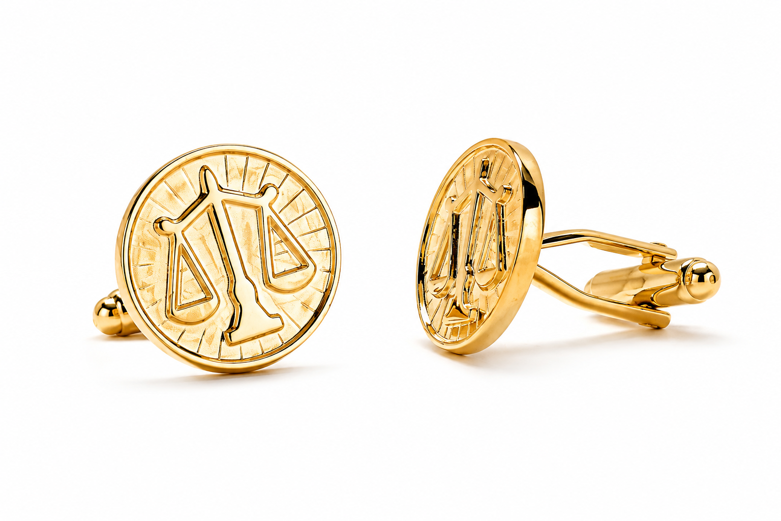 Gold cufflinks with Libra zodiac symbol design on a white background