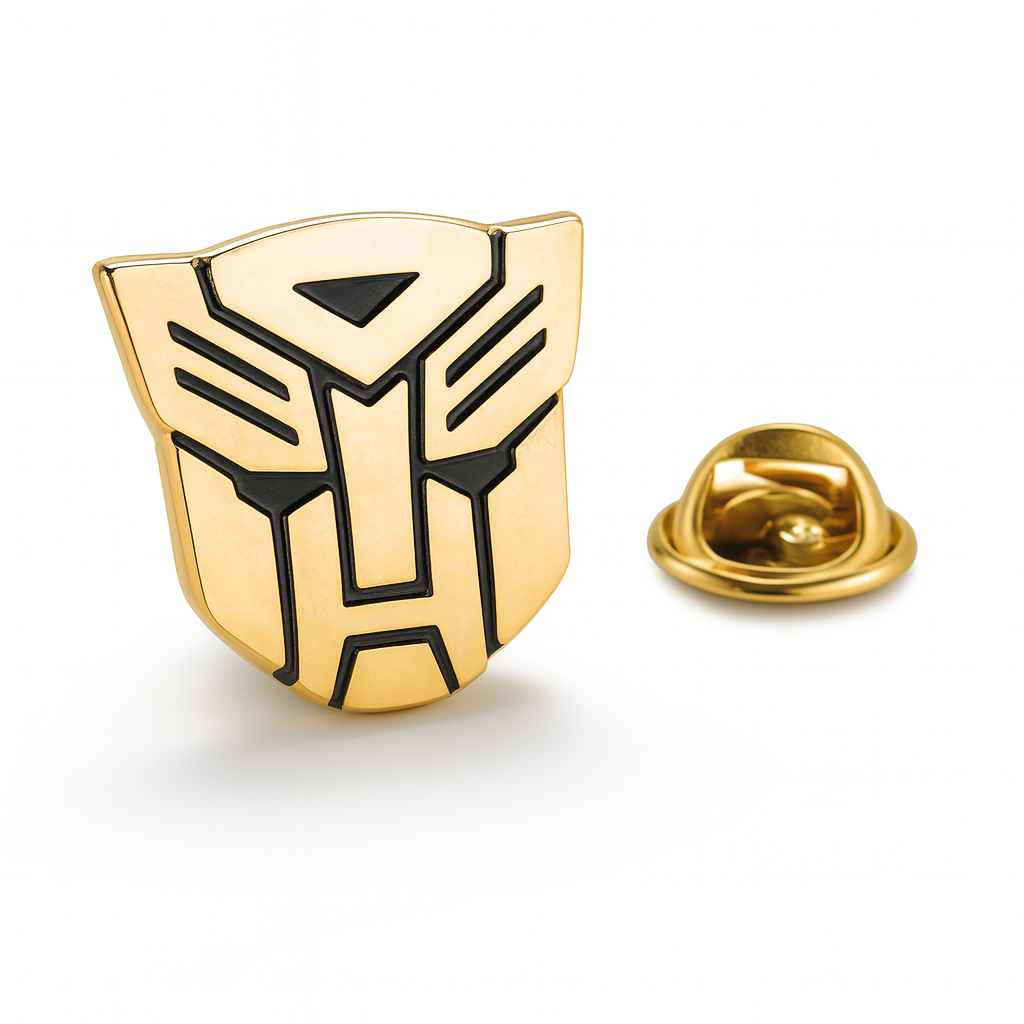 Gold and black emblem transformers Autobot pin on a white background
