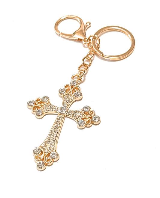 Gold cross keychain with rhinestones on a white background