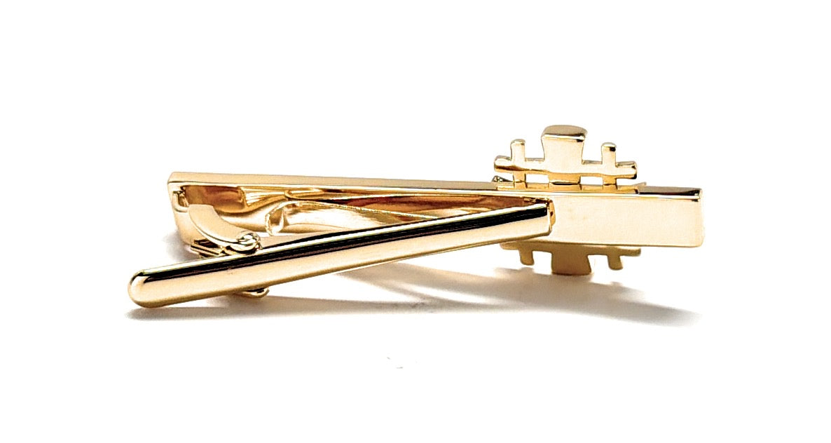 Gold tie clip on a white background