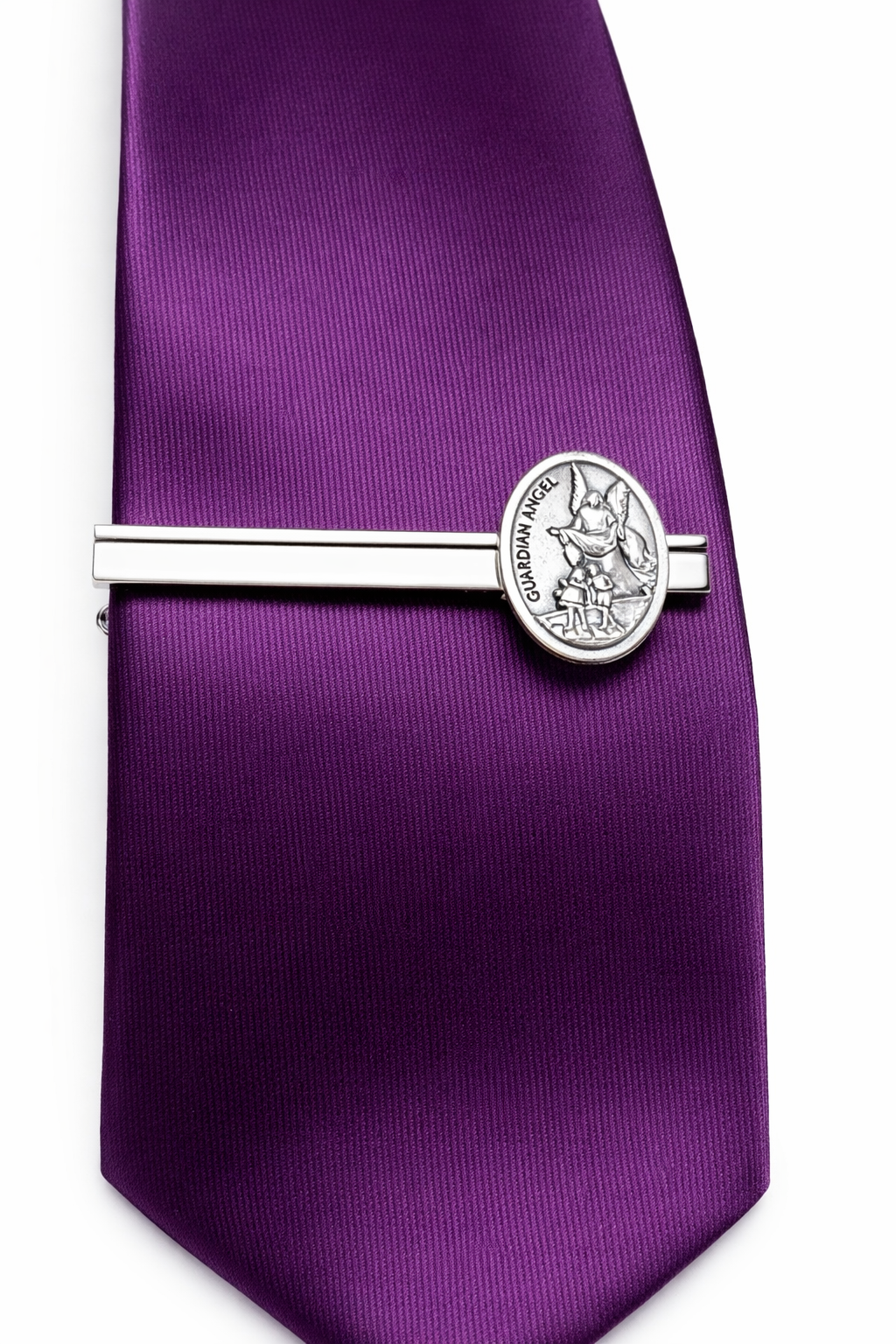 Silver tie clip on a purple tie against a white background