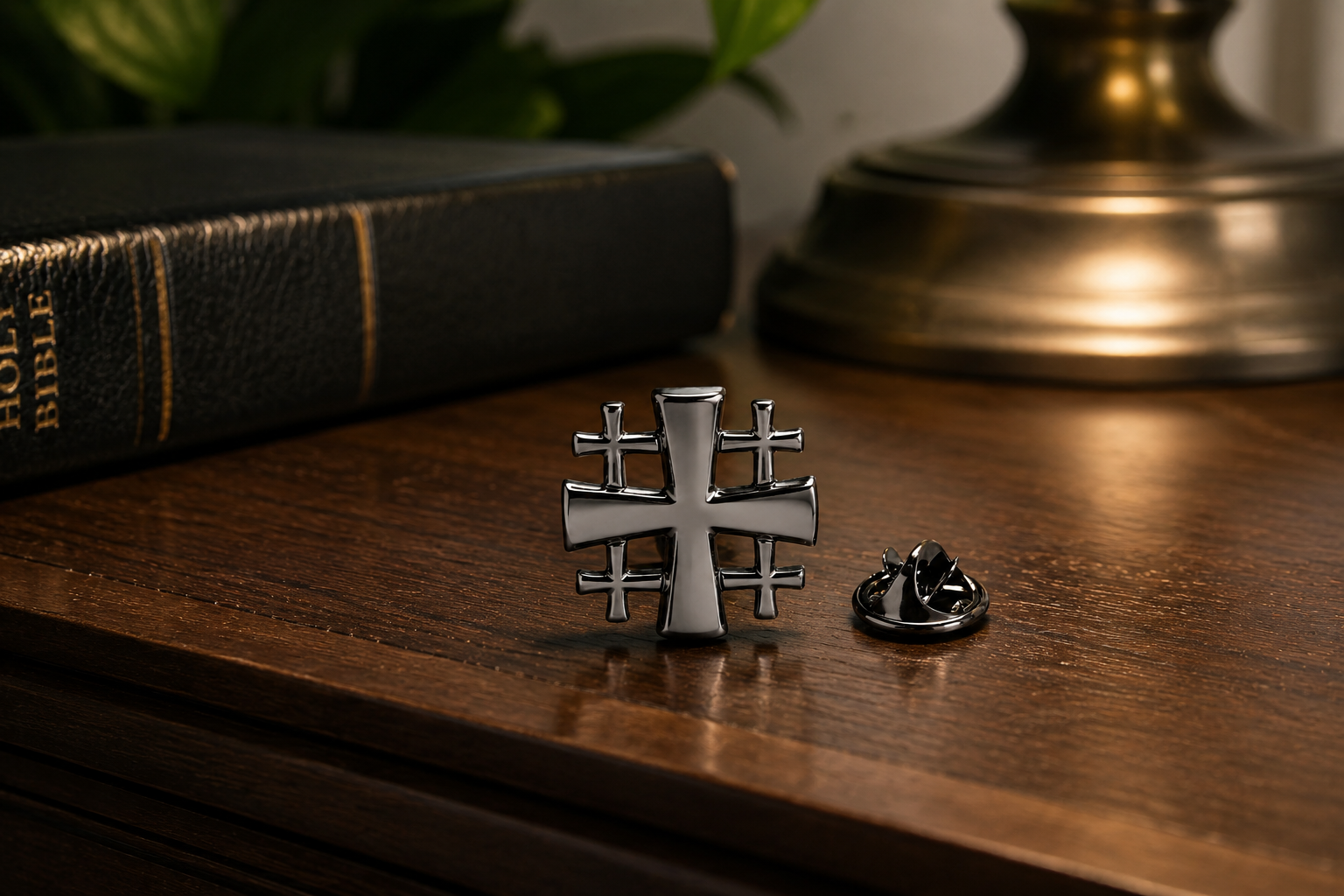 Jerusalem Cross lapel pin with Bible on wooden nightstand