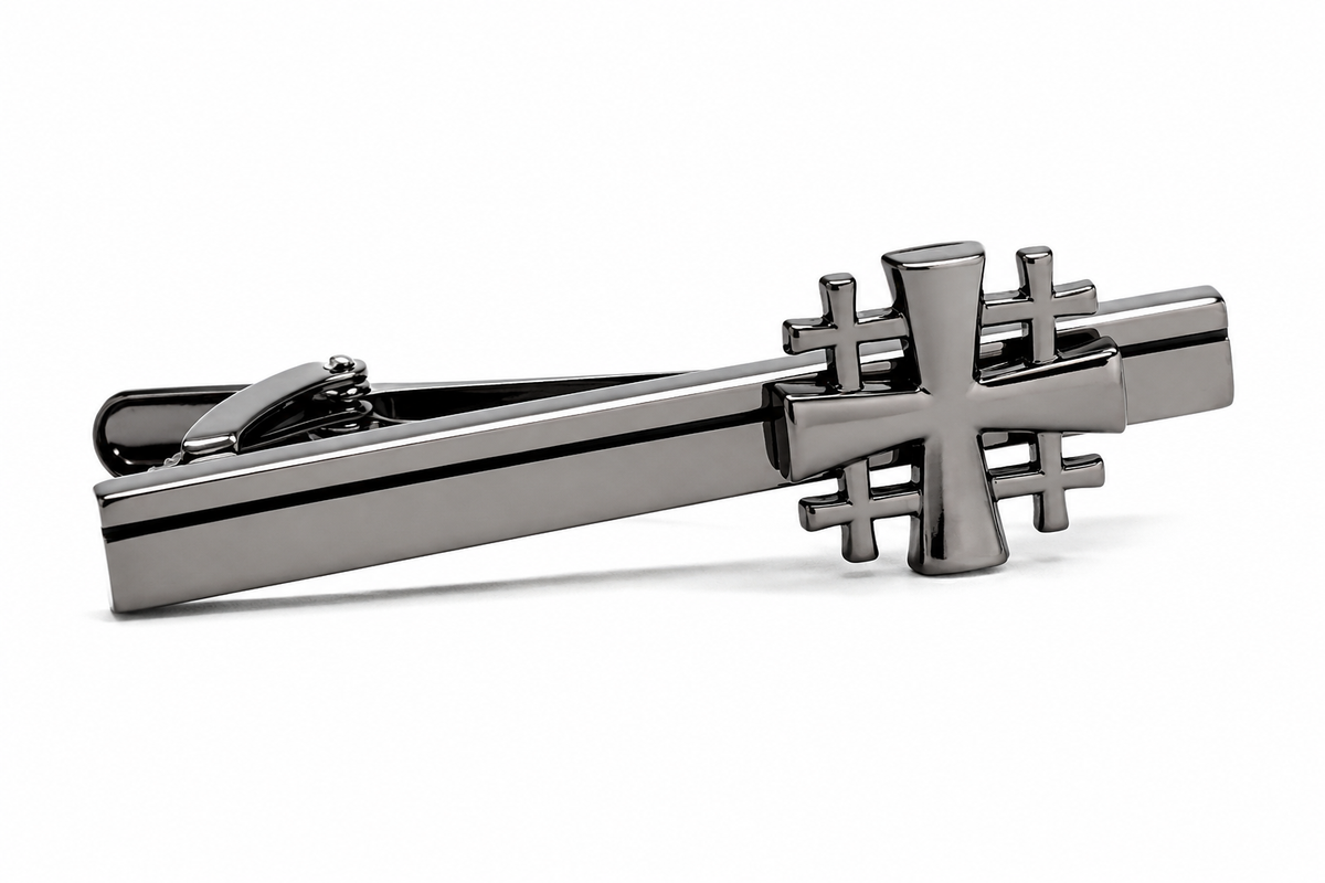 A polished dark gray metal Gunmetal Jerusalem Cross tie clip featuring a stylized cross design on the bar, photographed on a clean white background.
