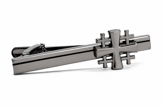 A polished dark gray metal Gunmetal Jerusalem Cross tie clip featuring a stylized cross design on the bar, photographed on a clean white background.