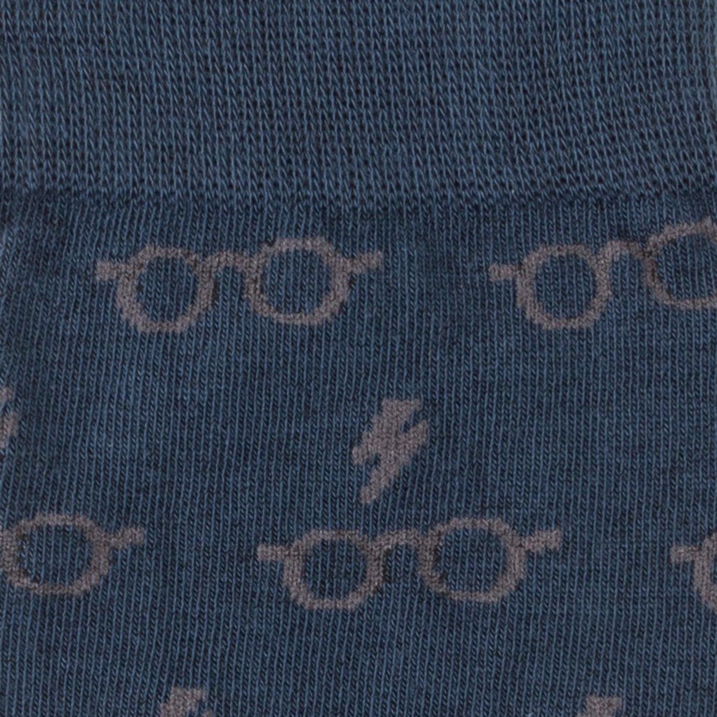 Close-up of blue fabric with glasses and lightning bolt pattern