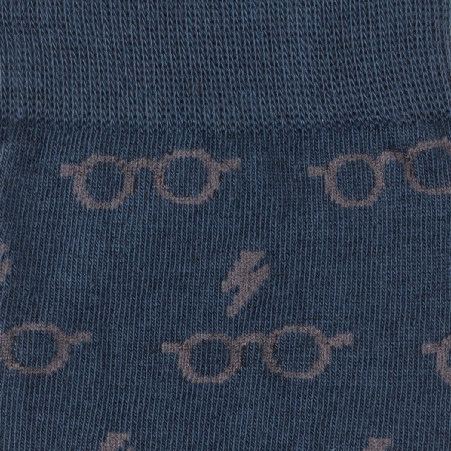 Close-up of blue fabric with glasses and lightning bolt pattern
