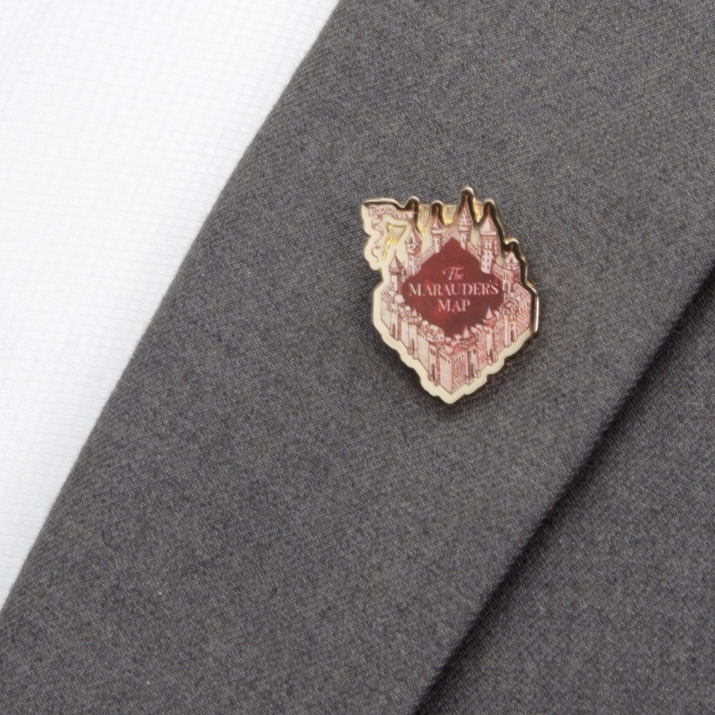 Pin with 'The Marauder's Map' design on a gray fabric background