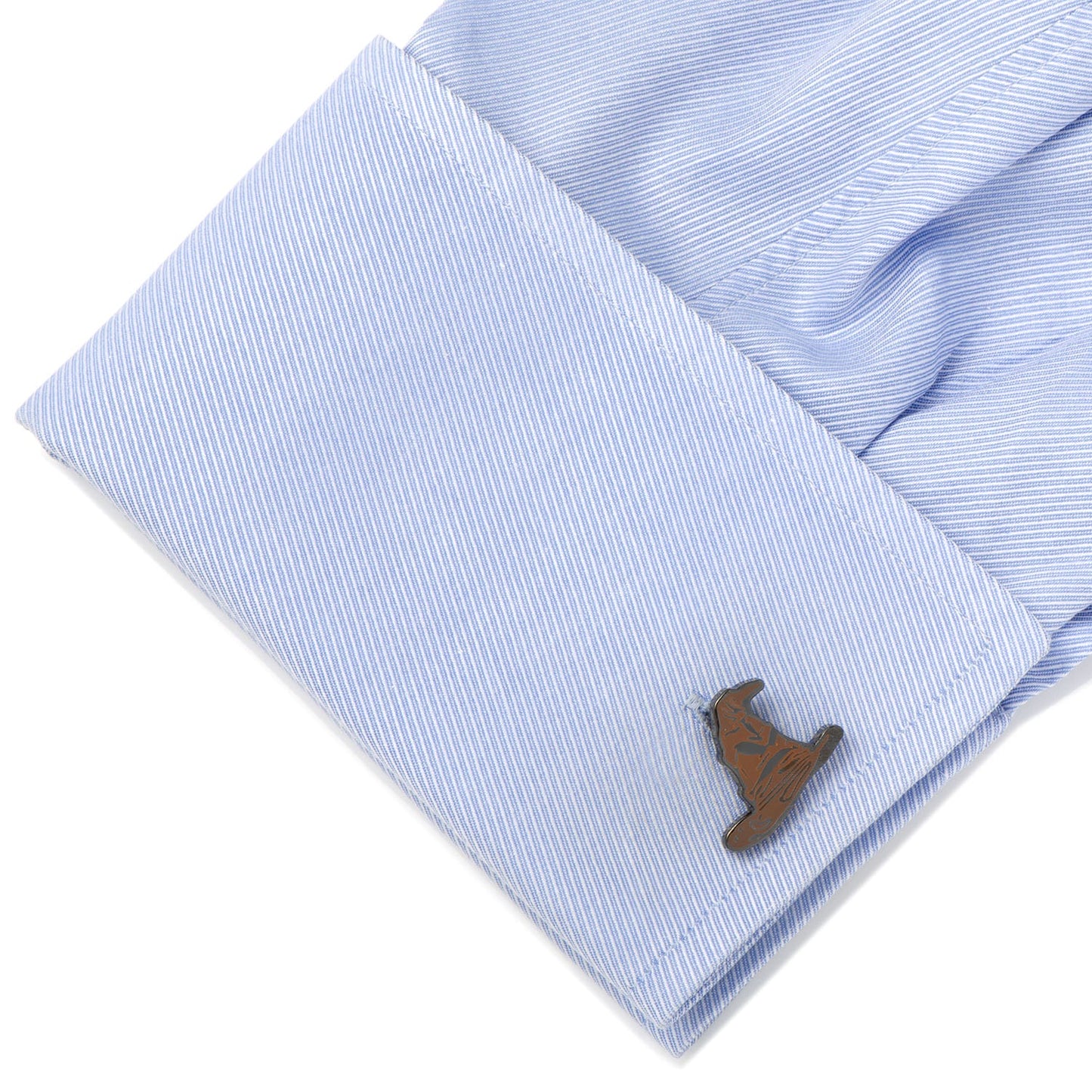 Close-up of a light blue shirt cuff with a wooden deer cufflink on a white background