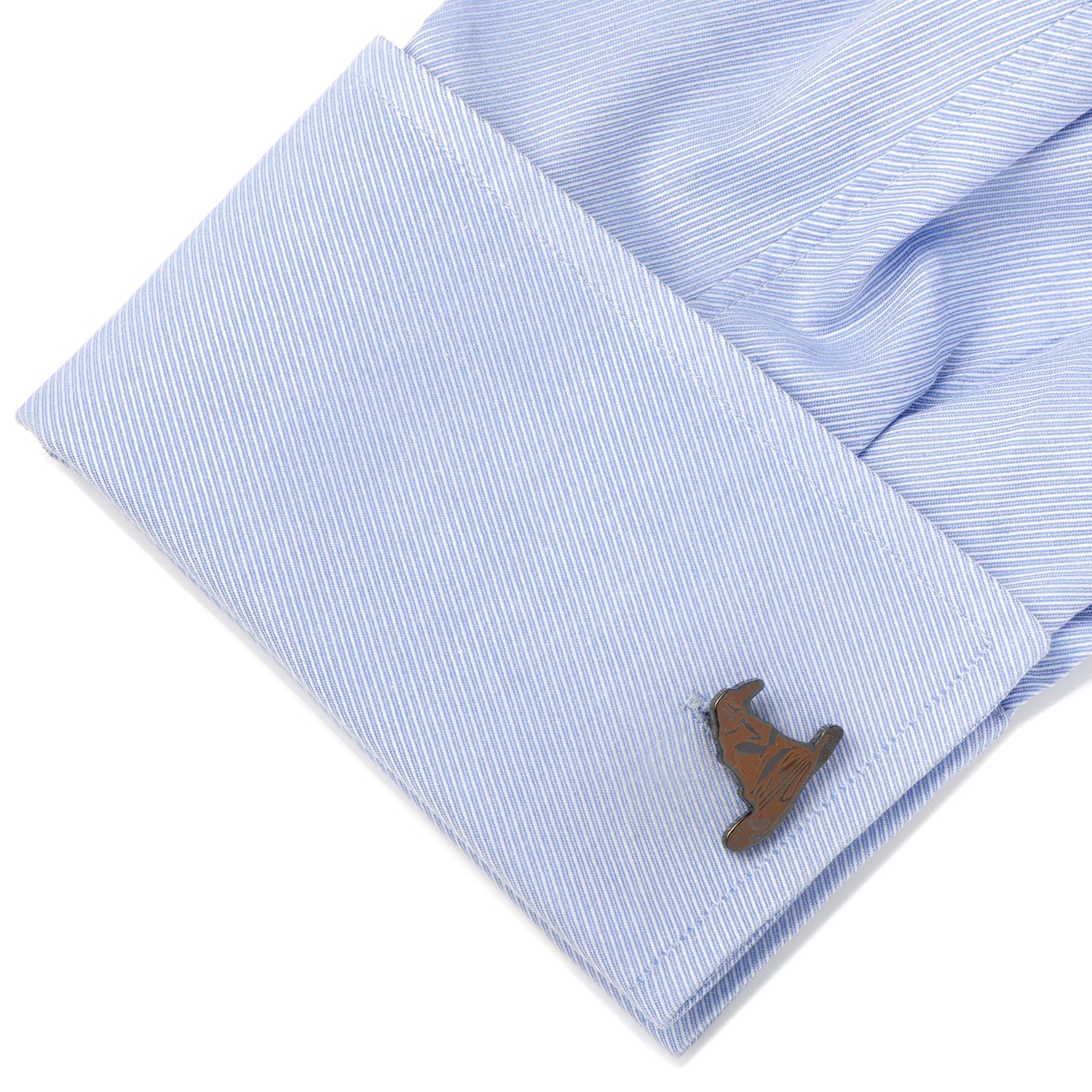 Close-up of a light blue shirt cuff with a wooden deer cufflink on a white background