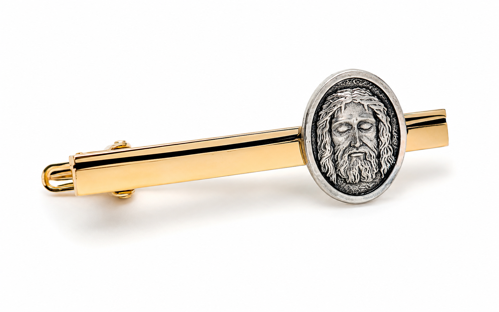 A gold and silver tie bar featuring an oval silver medallion with an embossed portrait of Jesus Christ, shown on a clean white background.
