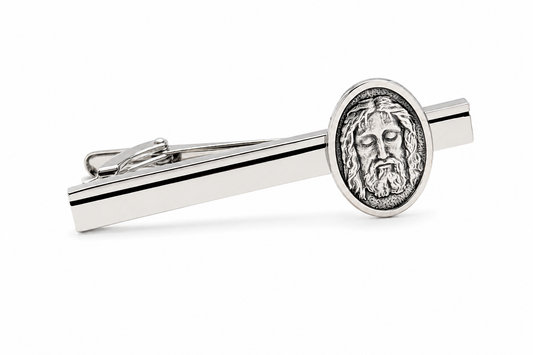 Silver tie clip with Jesus face design on a white background