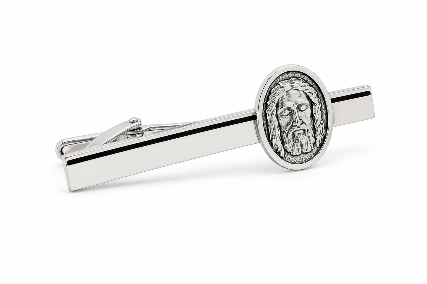 Silver tie clip with Jesus face design on a white background