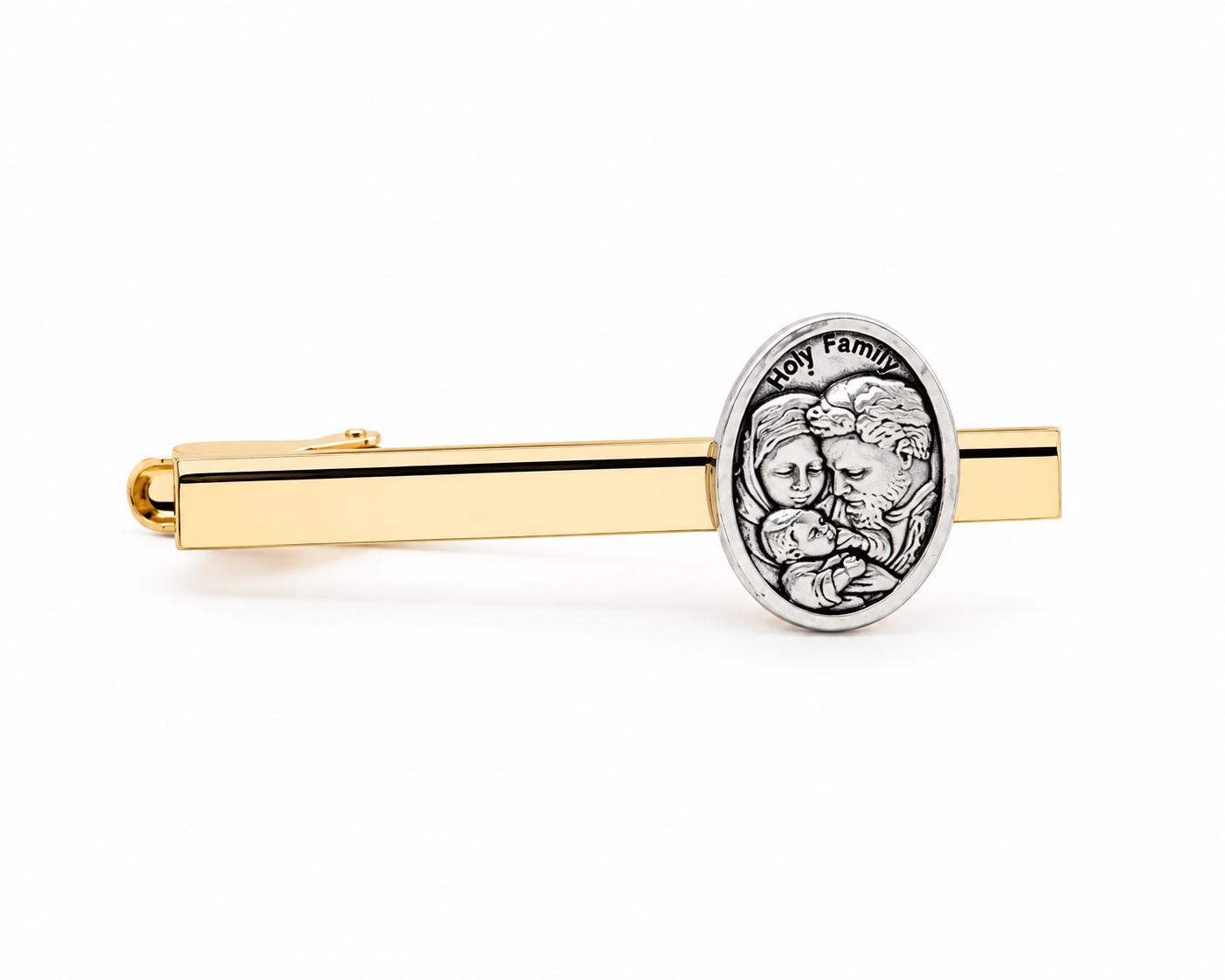 A gold tie bar featuring a silver oval medallion engraved with a family portrait and the words 'Holy Family'.