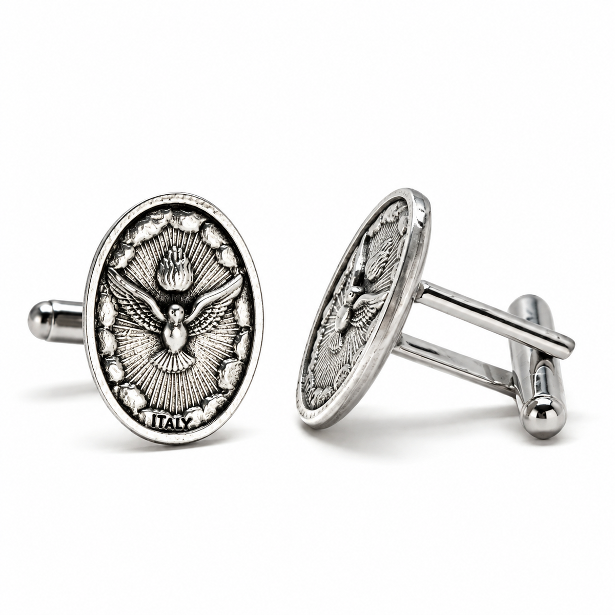 A pair of silver-toned oval cufflinks featuring an embossed dove of peace design, one shown from the front and the other from the side on a clean white background.