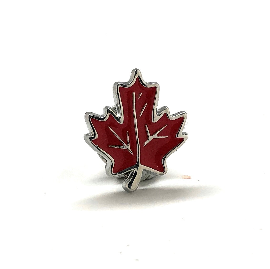 Red maple leaf lapel pin with silver outline and butterfly clasp displayed on white background