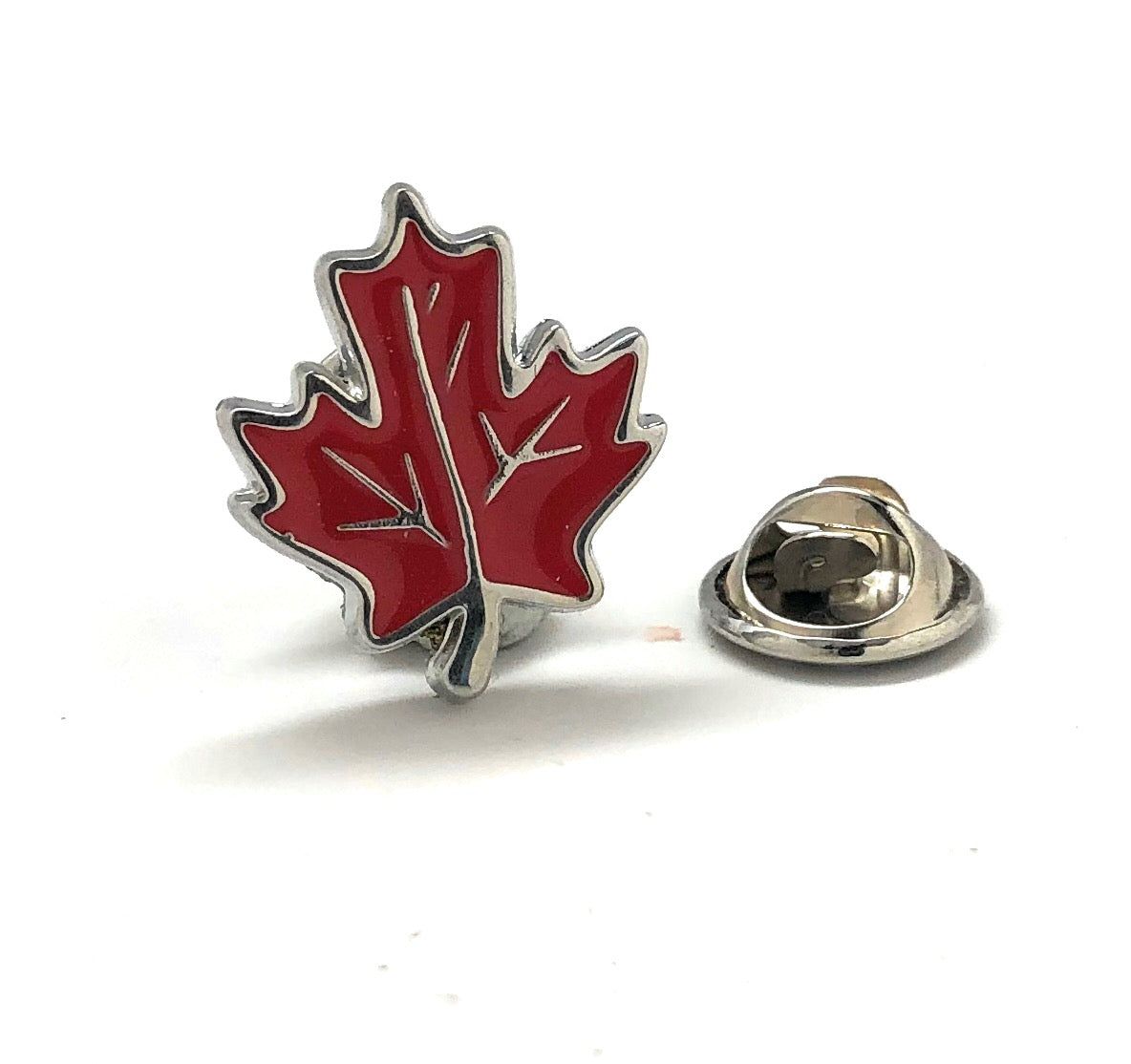 Red maple leaf lapel pin with silver outline and butterfly clasp displayed on white background