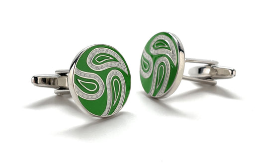Green and silver cufflinks on a white background