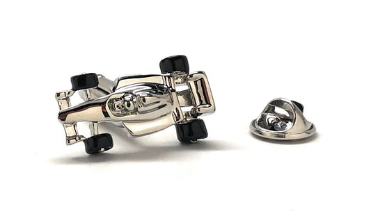 Metallic car-shaped cufflinks on a white background