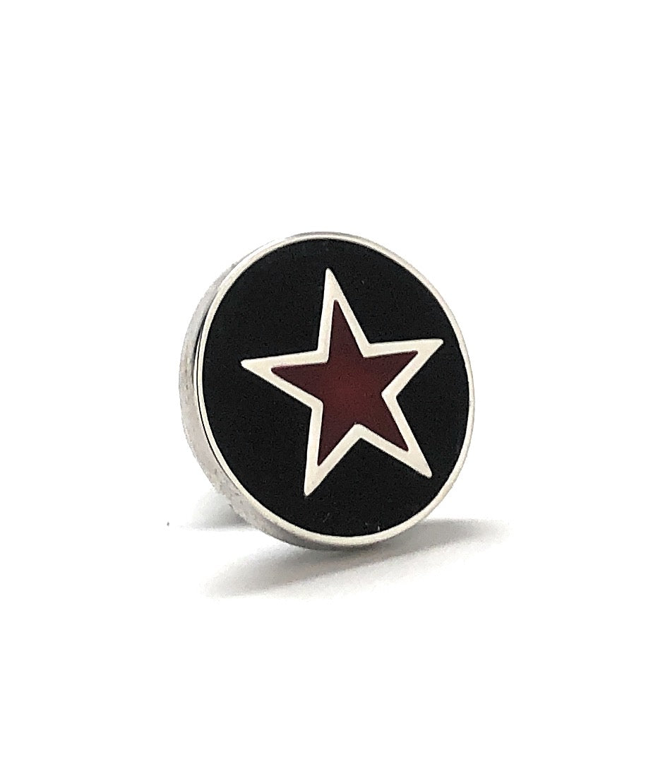 Round black object with a red star on a white background