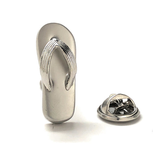 Metallic flip-flop shoe-shaped lapel pin on a white background