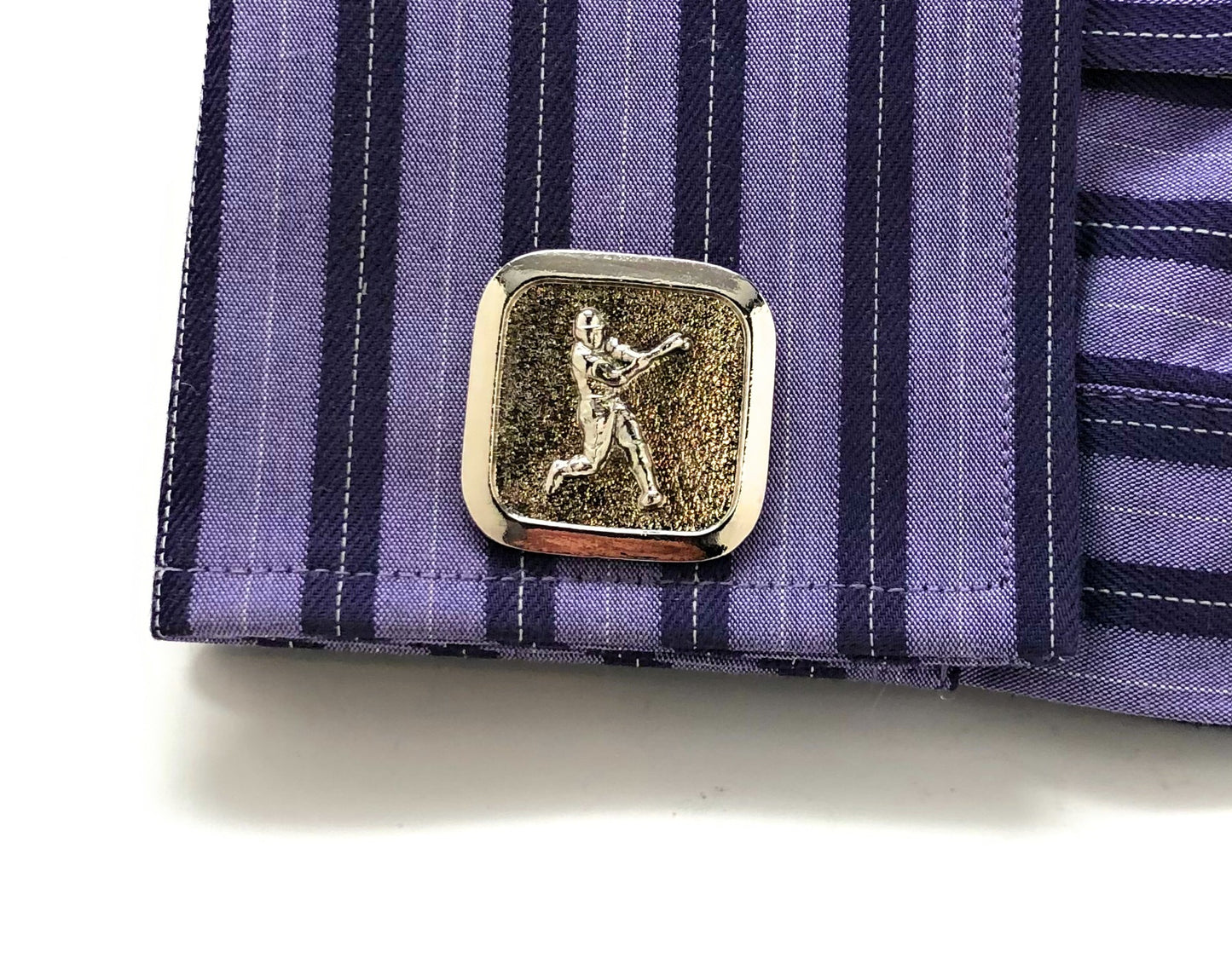 Cufflink on a purple striped shirt
