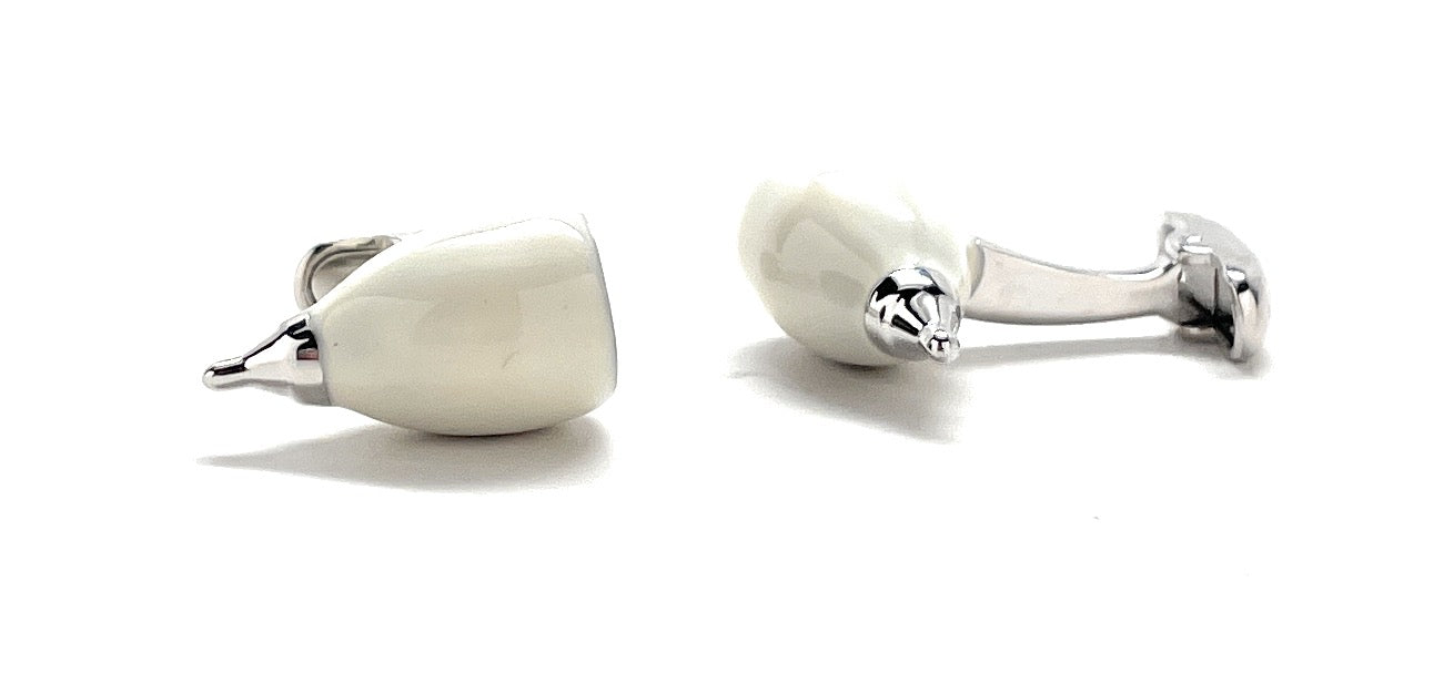 Pair of silver and white ceramic cufflinks on a white background