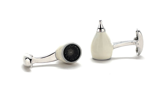Pair of cufflinks with silver and black design on a white background
