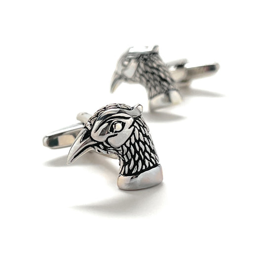 Silver horse head cufflinks on a white background