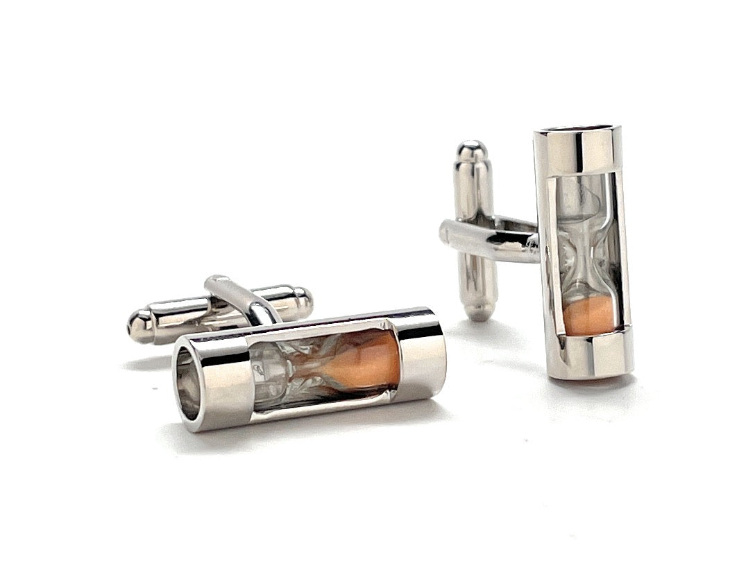 Silver cufflinks with cylindrical design on a white background