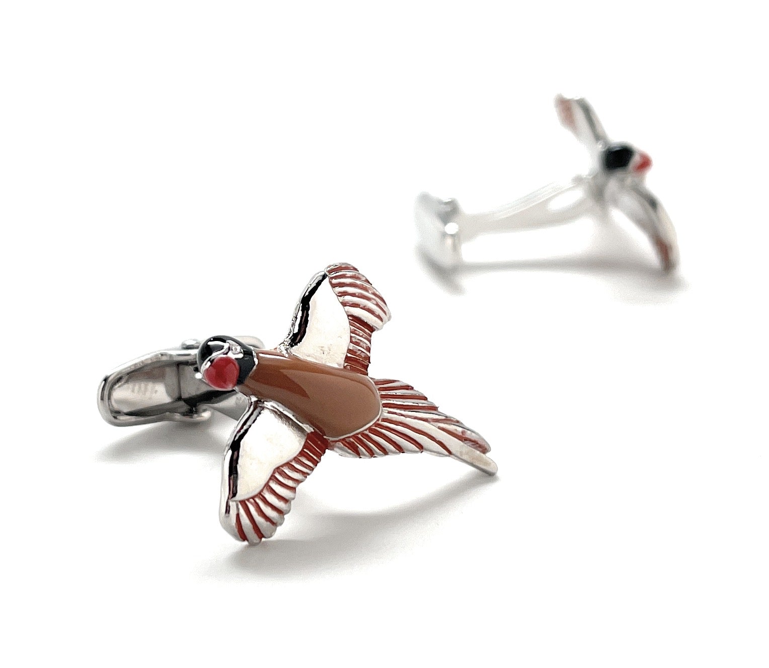 Bird-shaped cufflinks on a white background
