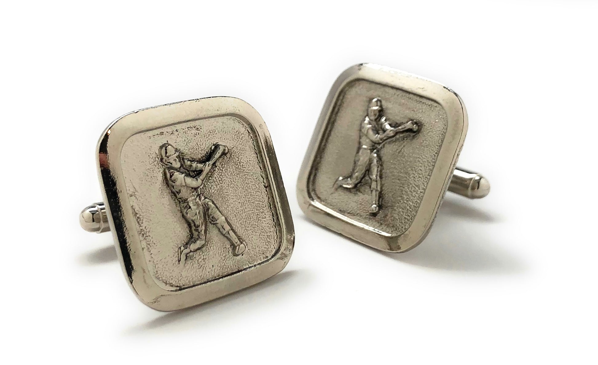 Pair of silver cufflinks with golf icon on a white background