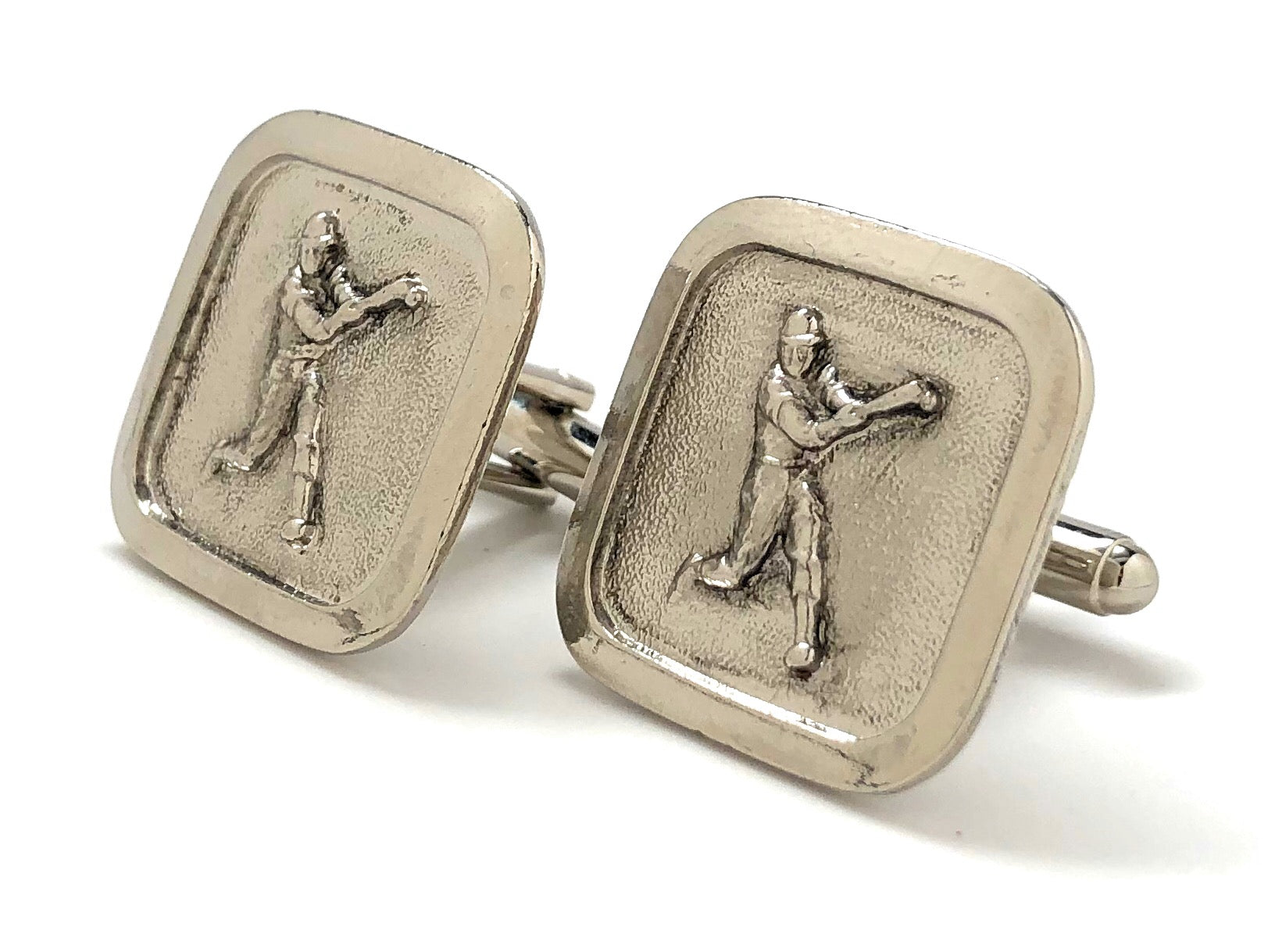 Silver cufflinks with golf-themed design on a white background