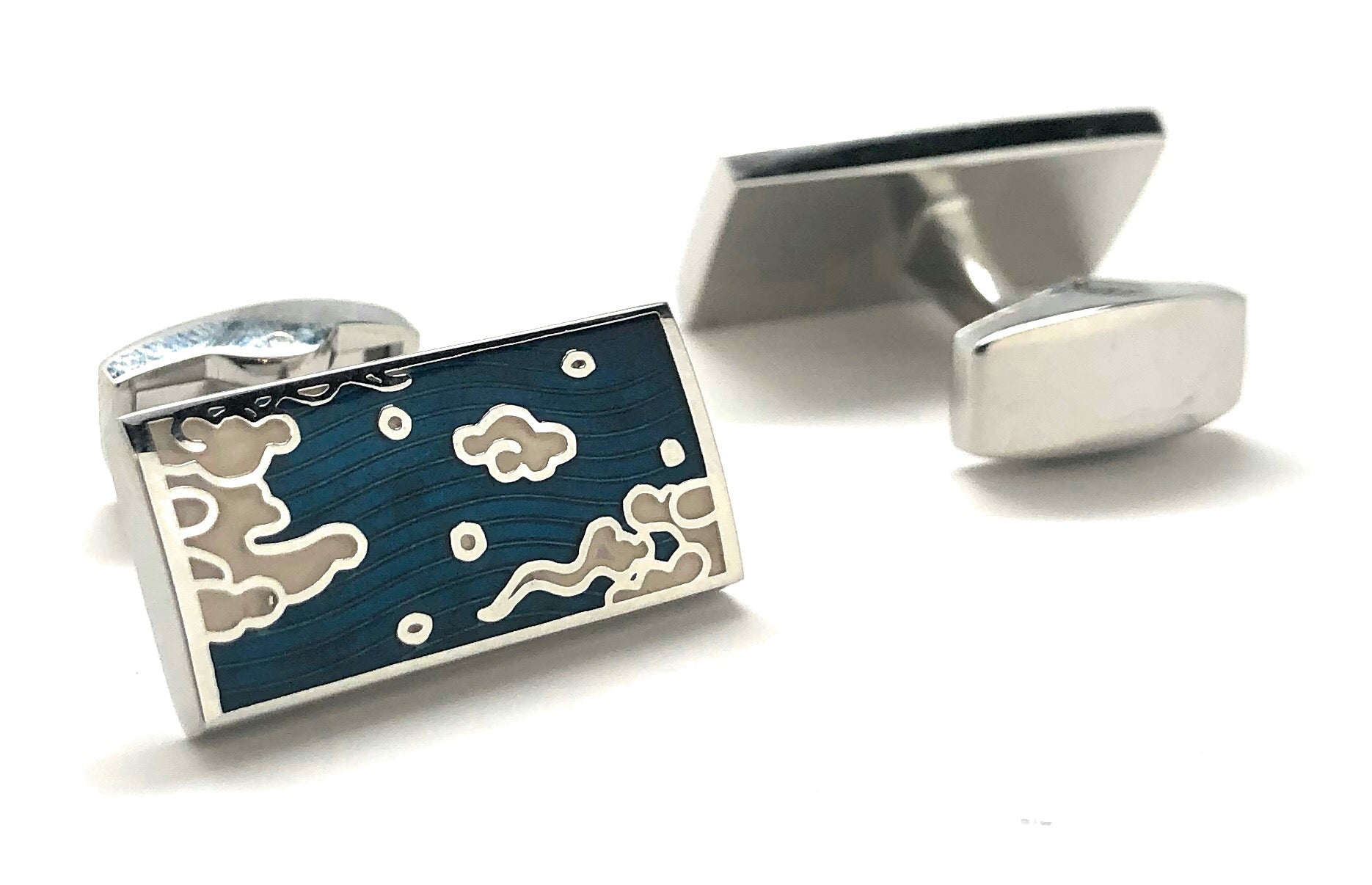 Cufflinks with a blue design featuring bears and clouds on a white background