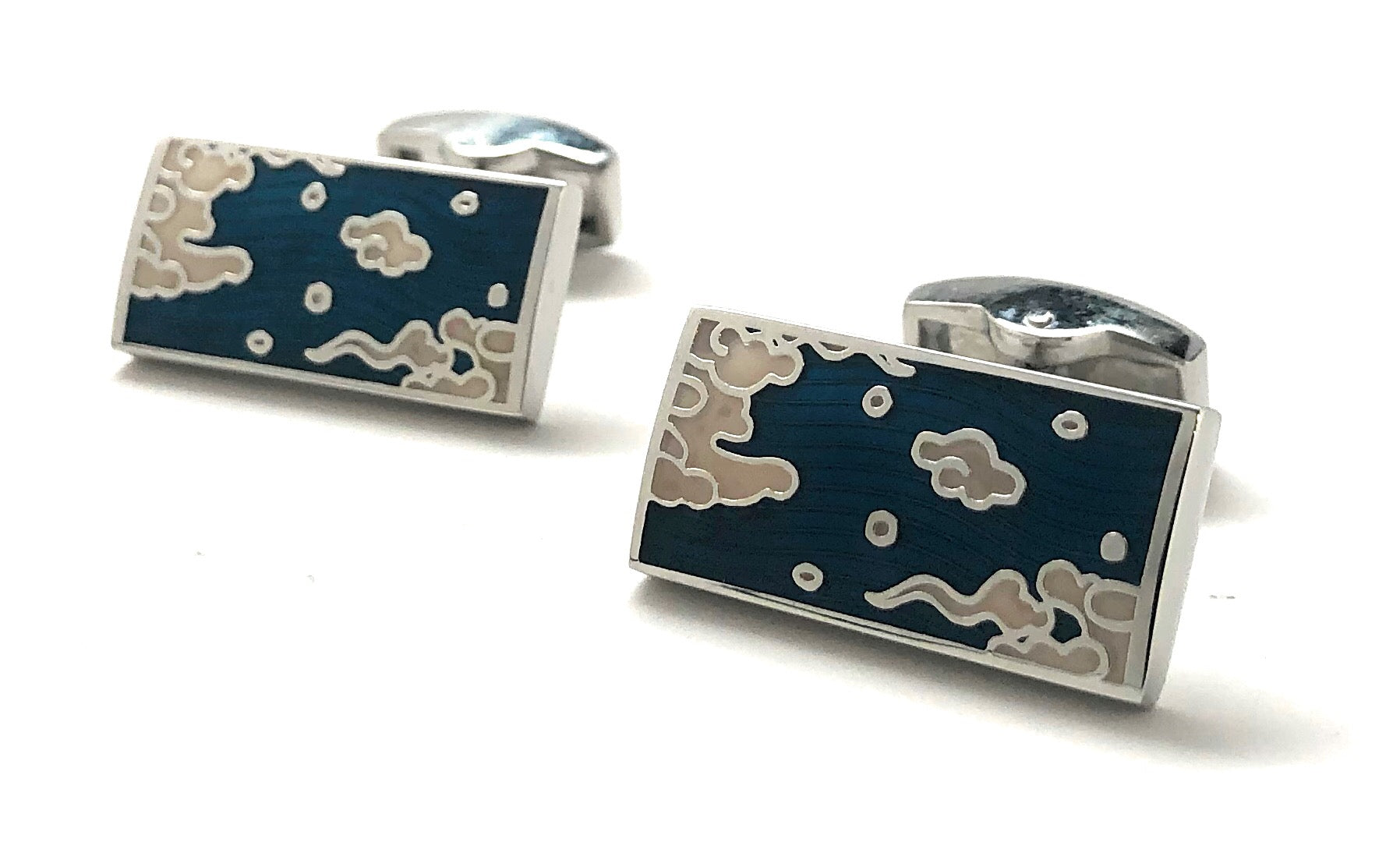 Cufflinks with a blue and silver design on a white background