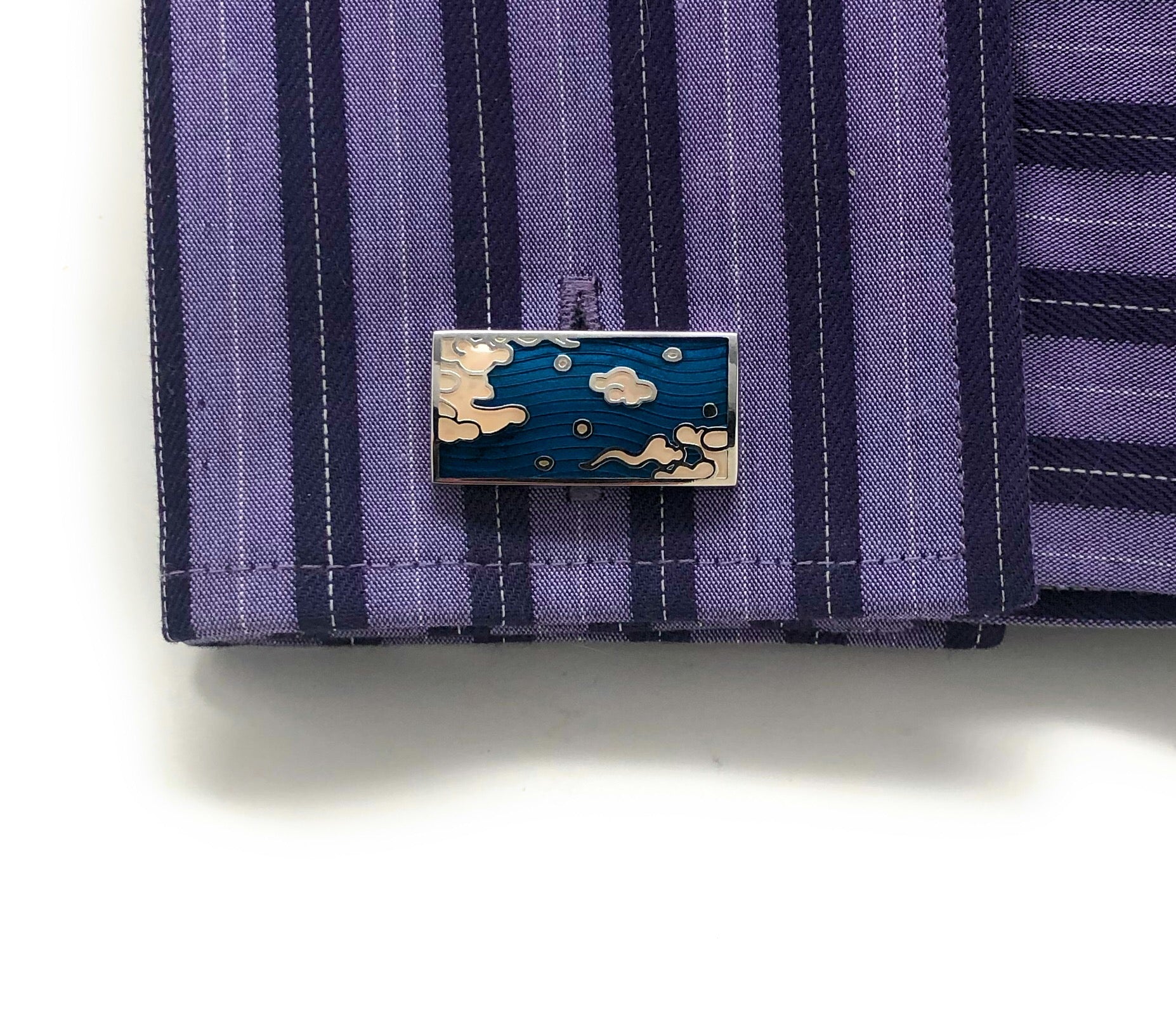 Decorative lapel pin on a striped shirt