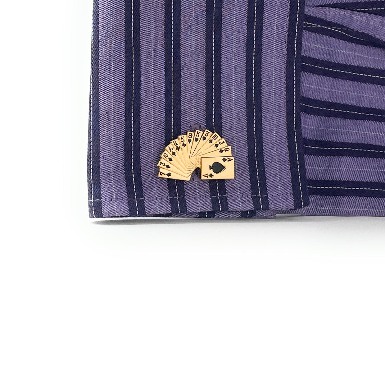 Gold playing card suit clip on a purple striped shirt