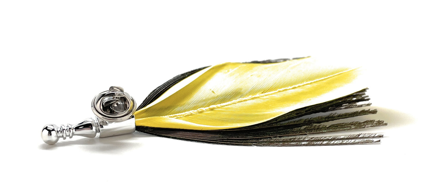 Close-up of yellow feather lapel pin with metal pin and clasp.