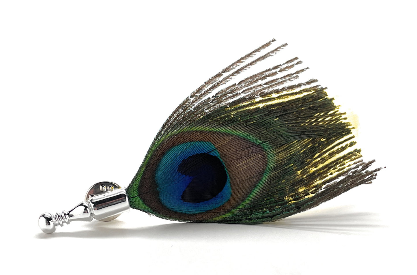 Peacock feather decorative item with a silver base on a white background lapel pin