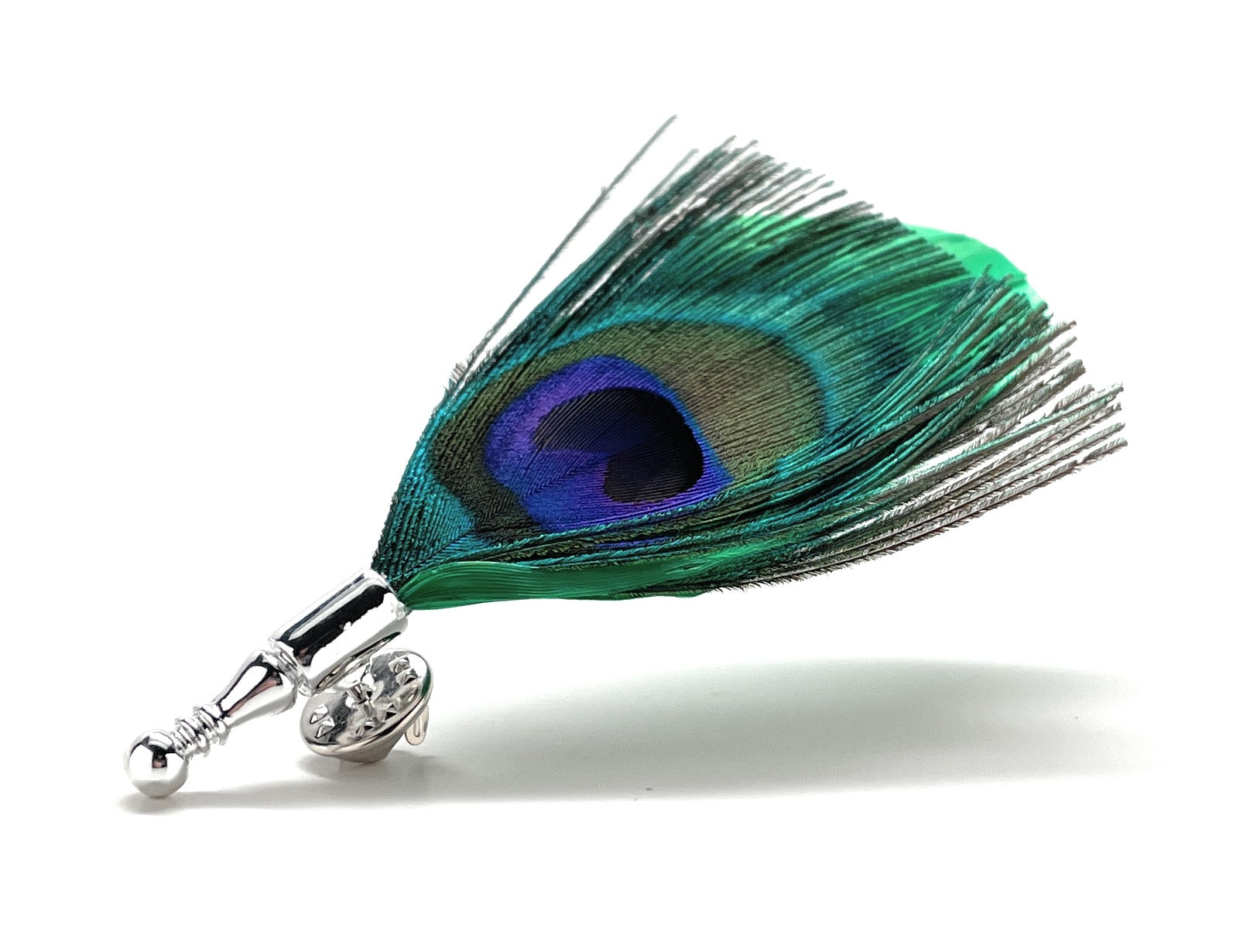 Side view of green feather lapel pin showing emerald accent feather and silver mount.