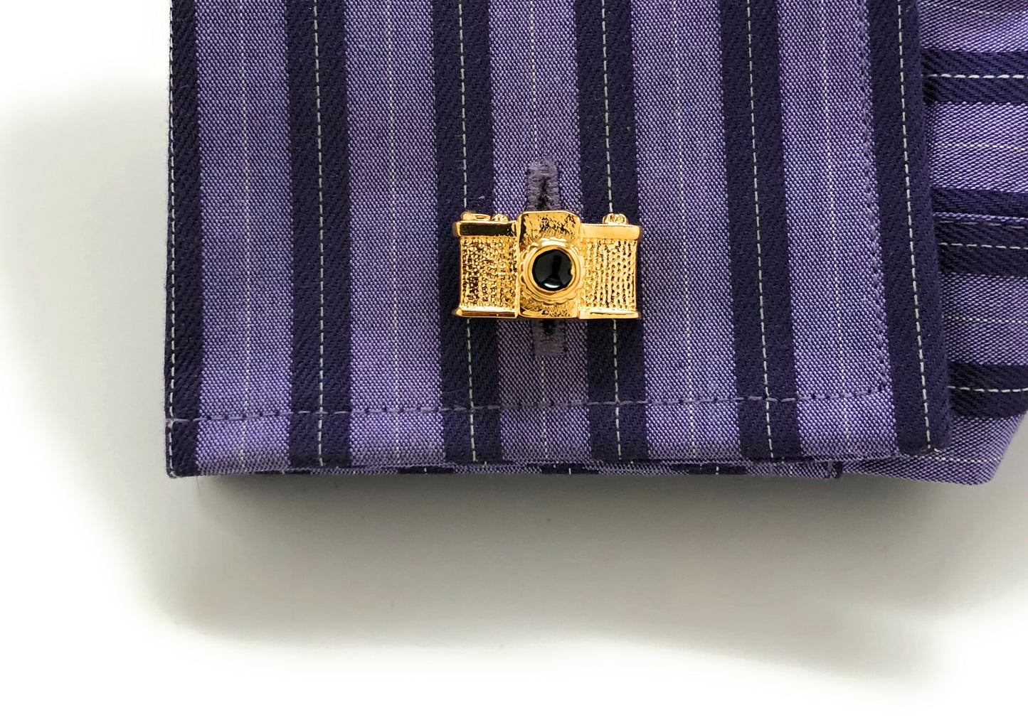 Gold vintage 35mm camera cufflinks with black enamel lens – retro photographer gift for men on purple shirt