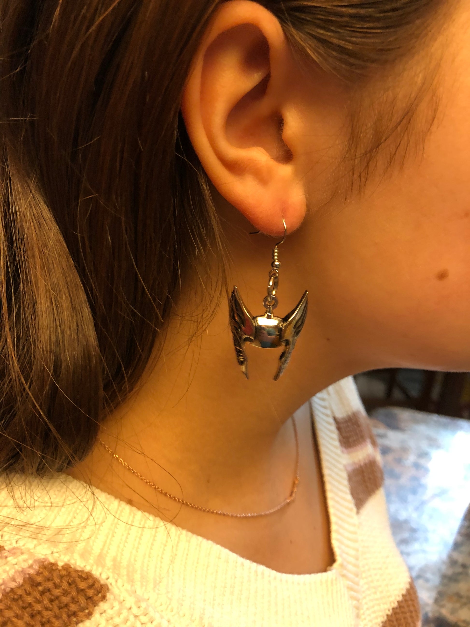 Close-up of a person wearing a star-shaped earring.