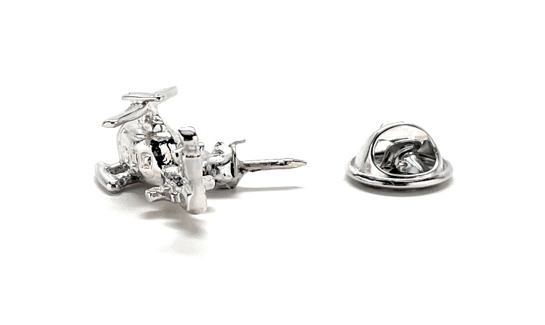 Silver earring and pin on a white background